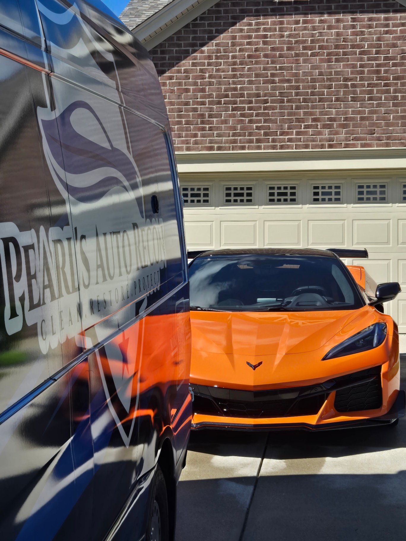 Orange Chevrolet Corvette C8 maintenance detail with Pearl's Auto Recon van